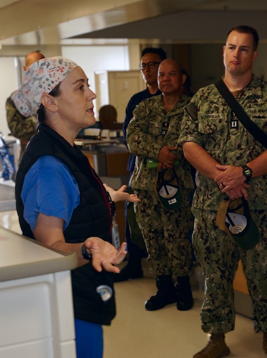 Lt. Stephanie Houser, Expeditionary Resuscitative Surgical System (ERSS) platform lead and emergency medicine physician assistant for U.S. Naval Hospital Guam, speaks with six Religious Ministry Teams representing three service branches within Joint Region Marianas during a Trauma Team Integration Training at U.S. Naval Hospital Guam on April 17, 2025. The training aims to enhance trauma readiness, improve patient care outcomes, and align with the Surgeon General’s 2025 Navy Medicine Campaign Order by integrating religious ministry into trauma response. The training emphasized the spiritual and emotional needs of both patients and medical personnel during trauma events. Chaplains play a crucial role in post-event debriefings by offering emotional support, promoting team cohesion and helping to improve future performance and outcomes. (U.S. Navy photo by Petty Officer Tnyka Thomas)