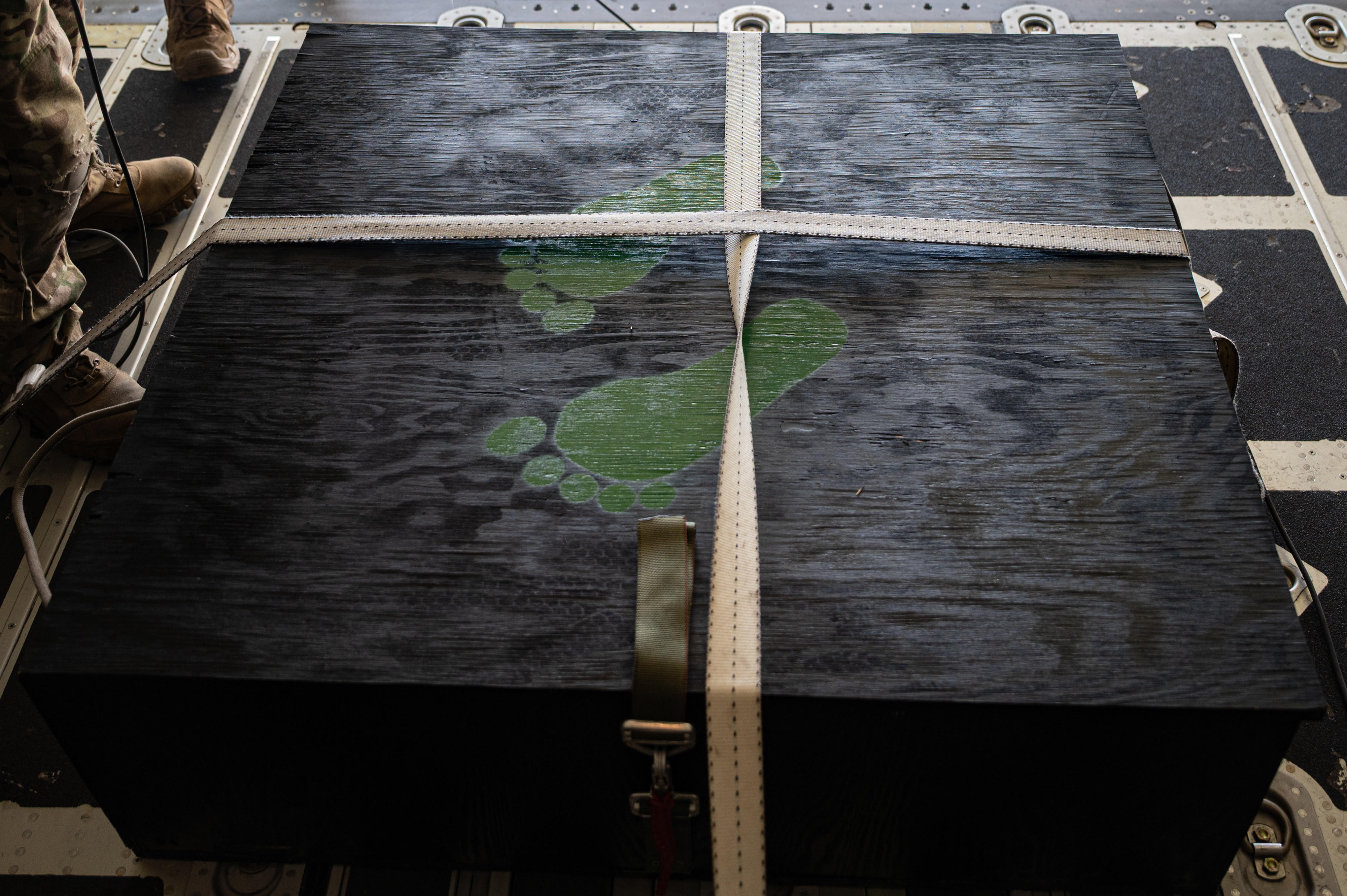 A wooden box containing a memorial dedicated to U.S. Air Force Capt. Joel Gentz in an HC-130J Combat King II, assigned to the 79th Rescue Squadron (RQS), at Nellis Air Force Base(AFB), Nevada, April 23, 2025. 58th RQS and 79th RQS Airman coordinated to deliver the Gentz memorial to Kirtland AFB, New Mexico. (U.S. Air Force Photo by Airman 1st Class Michael Sanders)