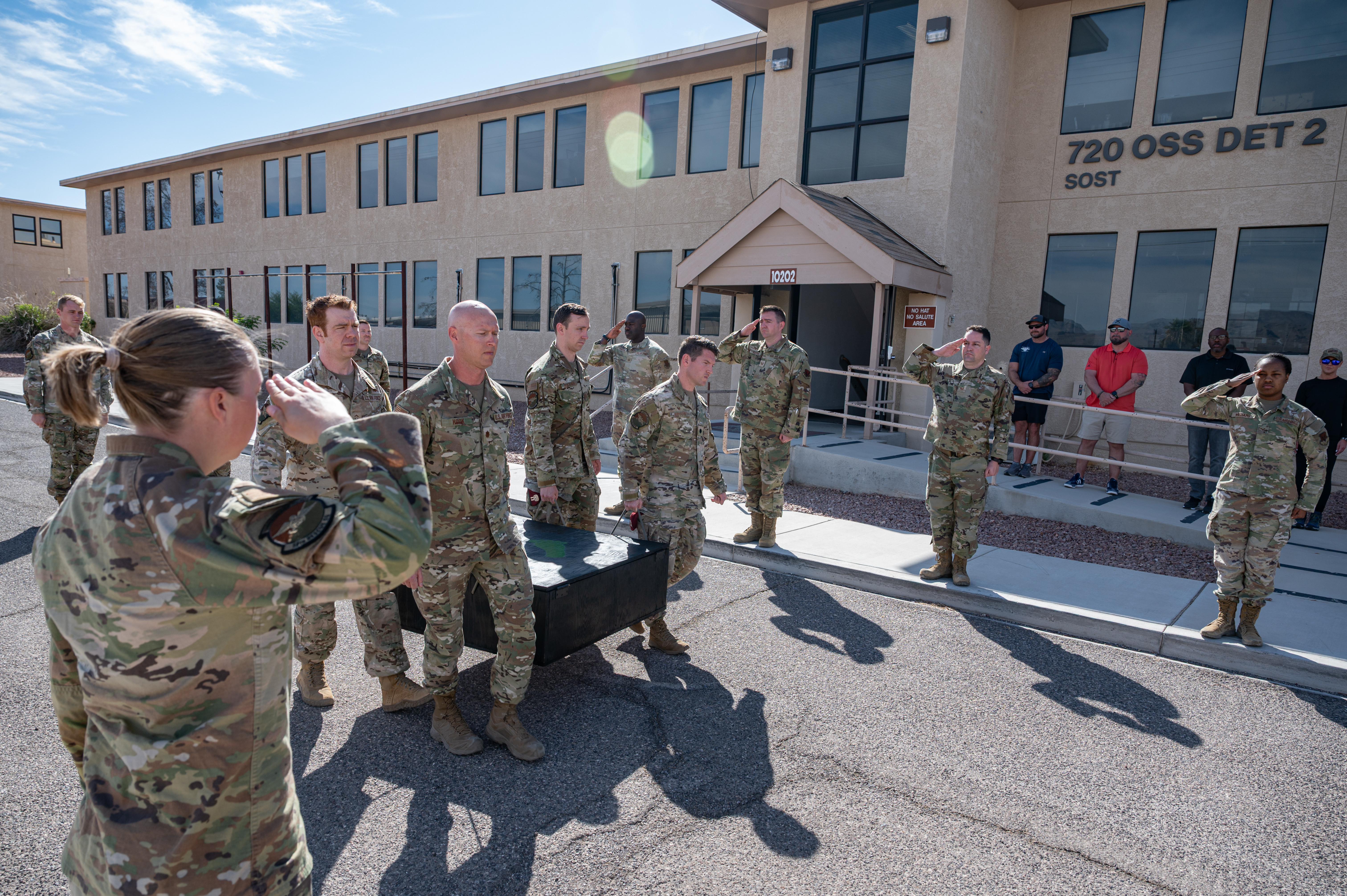 A U.S. Air Force 58th Rescue Squadron command team carries the memorial of Capt. Joel Gentz past 58th RQS members at Nellis Air Force Base, Nevada, April 23, 2025. Gentz lost his life on a mission in Afghanistan while saving others, embodying the RQS motto, “courage and honor.” (U.S. Air Force Photo by Airman 1st Class Michael Sanders)