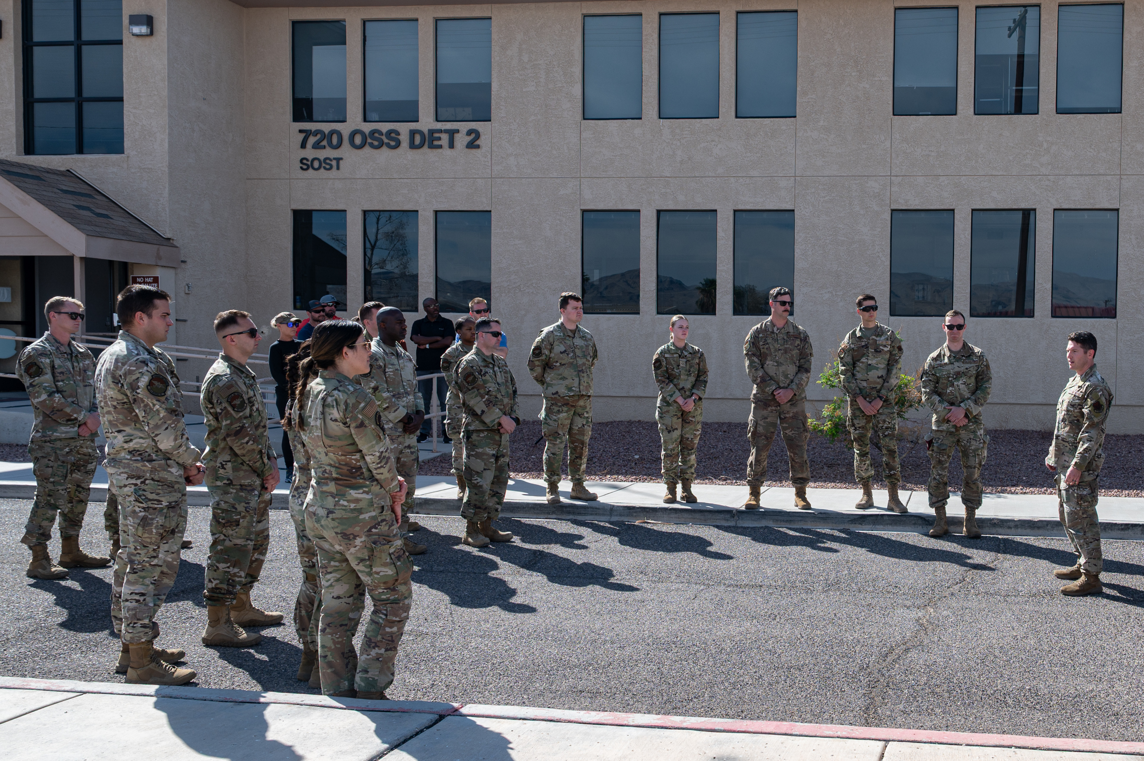 U.S. Air Force Lt. Col. Jeff Edson, right, 58th Rescue Squadron (RQS) commander, delivers a speech in honor of Capt. Joel Gentz outside of the Gentz Memorial Schoolhouse at Nellis Air Force Base, Nevada, April 23, 2025. Gentz is remembered by current rescue Airmen as an inspiration to their motto, “courage and honor.” (U.S. Air Force Photo by Airman 1st Class Michael Sanders)