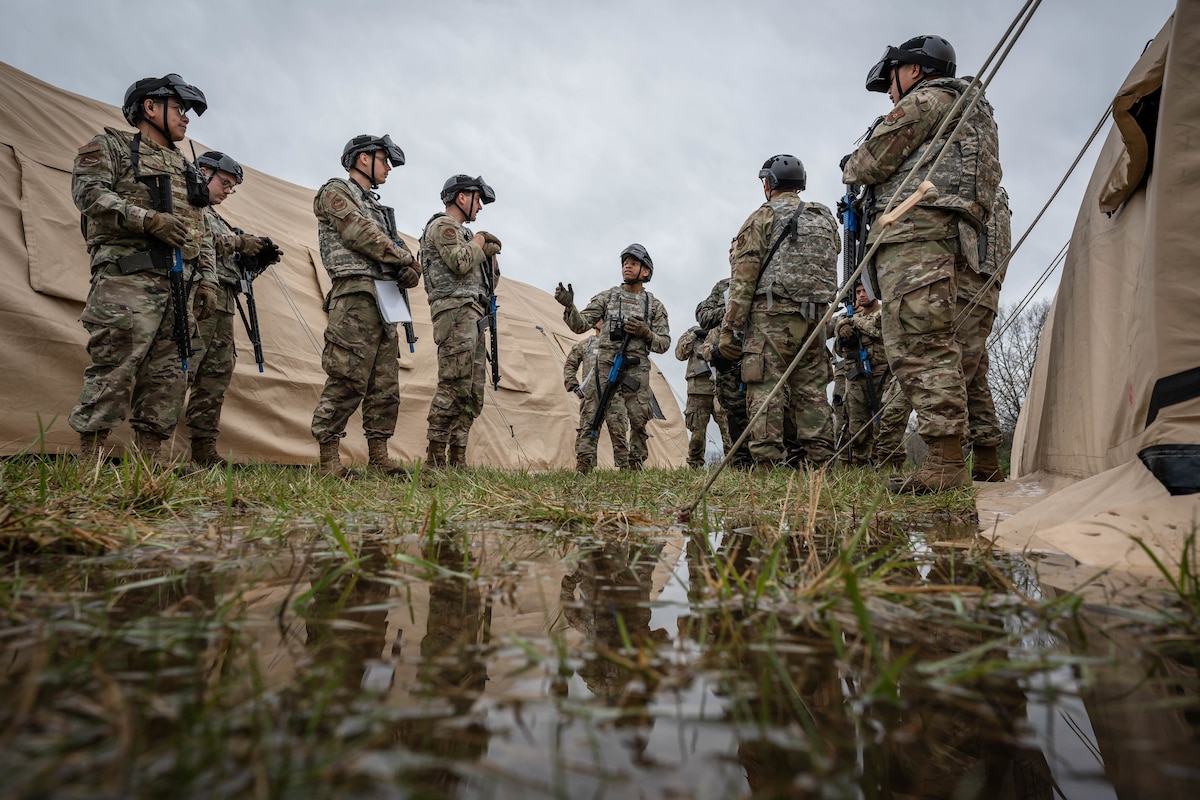 Ground transportation operators assigned to the 509th Logistics Readiness Squadron discuss training tactics during a field training exercise at Whiteman Air Force Base, Missouri, April 3, 2025. The exercise incorporated convoy transport and route reconnaissance, bare base operations, casualty carries, trauma response, and battle drills in a simulated combat environment. (U.S. Air Force photo by Senior Airman Joshua Hastings)