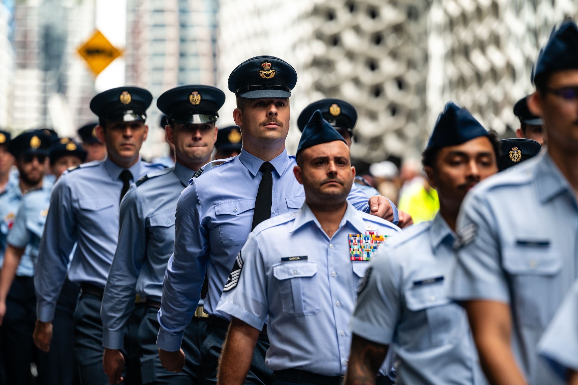 U.S. Air Force Airmen march along side Royal Australian Air Force members during New Zealand Army Corps day in Brisbane.