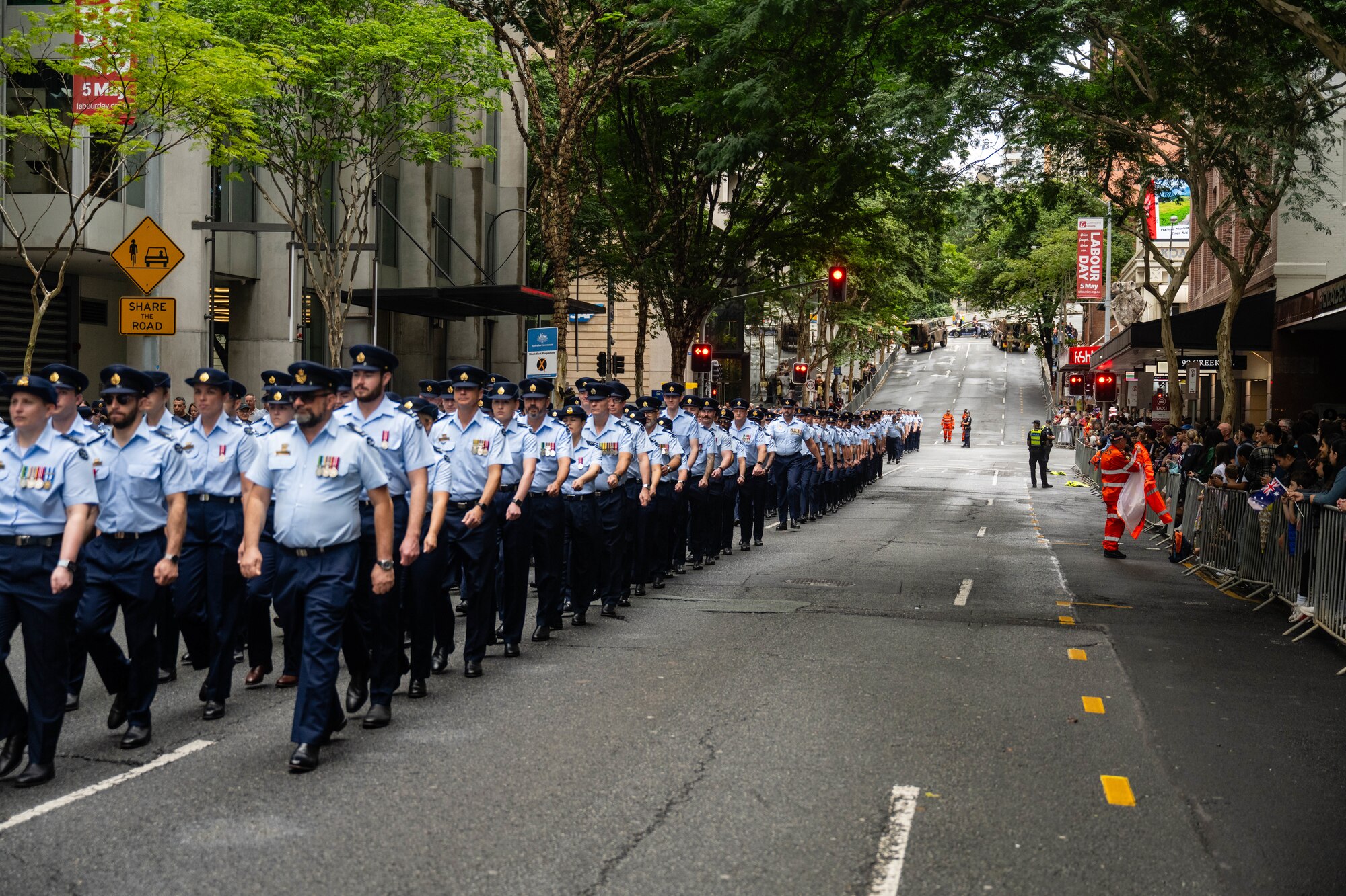U.S. Air Force Airmen and Royal Australian Air Force march along side each other.