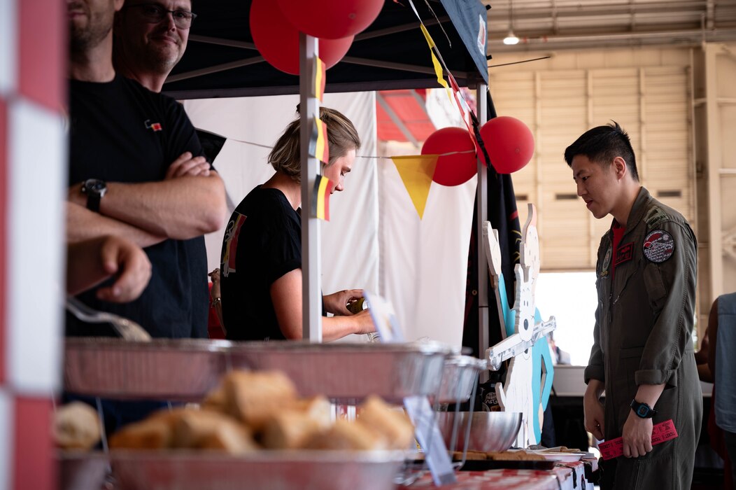 Belgian partners assigned to the 312th Fighter Squadron distribute food and drinks from their home country to attendees of Allies and Partners Day