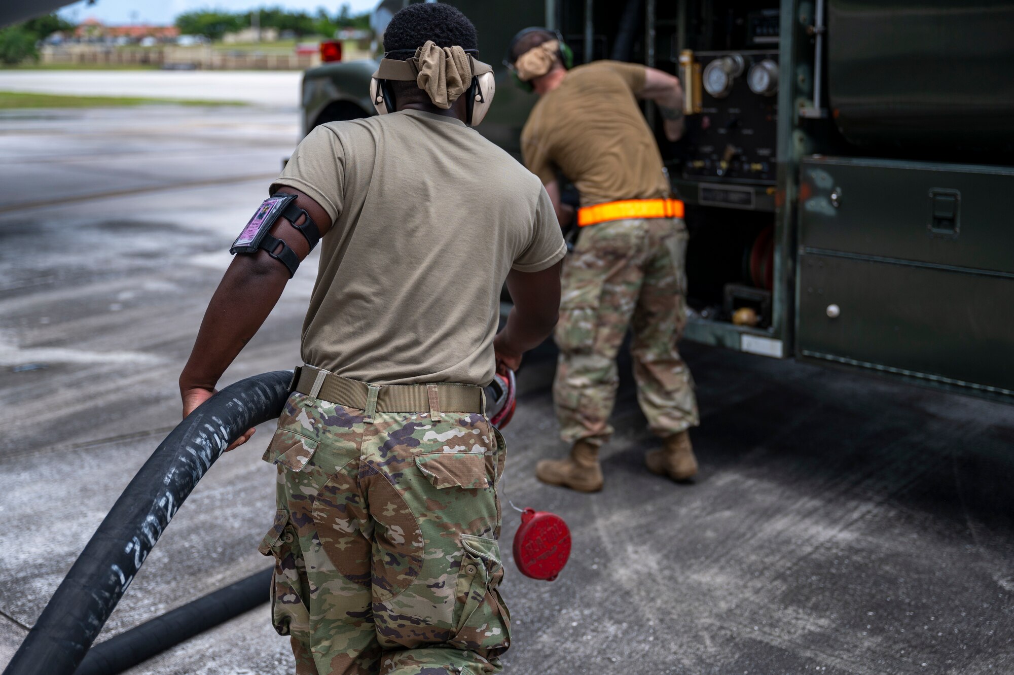 An Airman from the 9th Airlift Wing returns a fuel hose to a R-11 refueler vehicle at Andersen Air Force Base, Guam, April 29, 2025. The Airmen trained during Project Carabao to become multi-capable airmen. Multi-capable Airmen are trained to perform tasks outside of their primary Air Force Specialty Code. (U.S. Air Force Photo by Airman Xavier Romero)