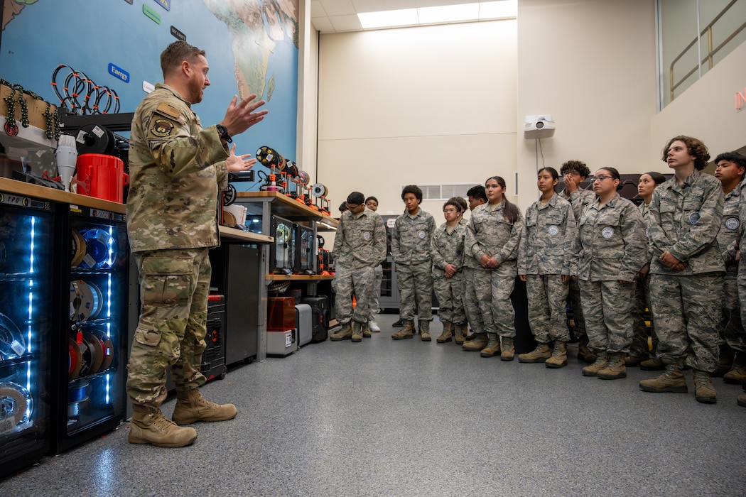 An Airman briefs the JROTC tour on Travis Air Force Base