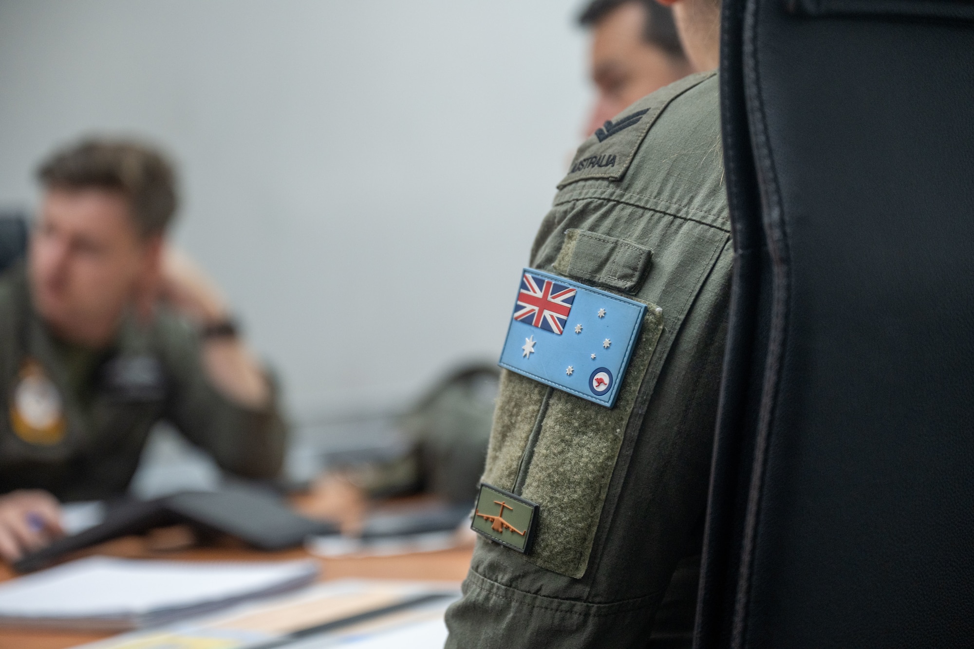 Royal Australian Air Force pilots sit around a conference table and plan future operations in Brisbane, Queensland, Australia.