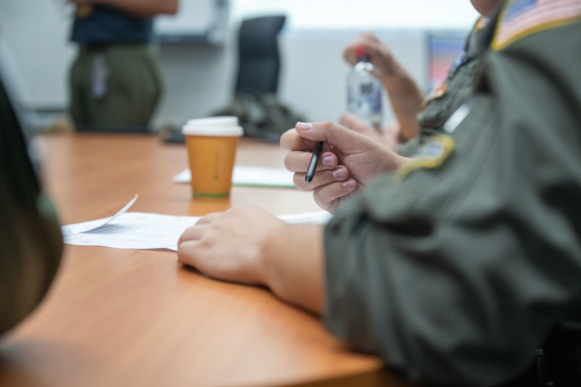 U.S. Air Force aircrews sit around a conference table and plan out future operations in Brisbane, Queensland, Australia.