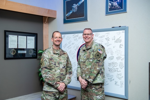 Two men in uniform stand next to each other