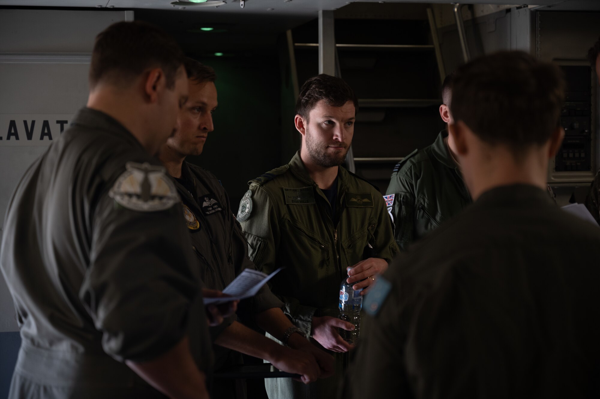 Royal Canadian aircrew listen in on pre-flight briefing for their C-17 flight.