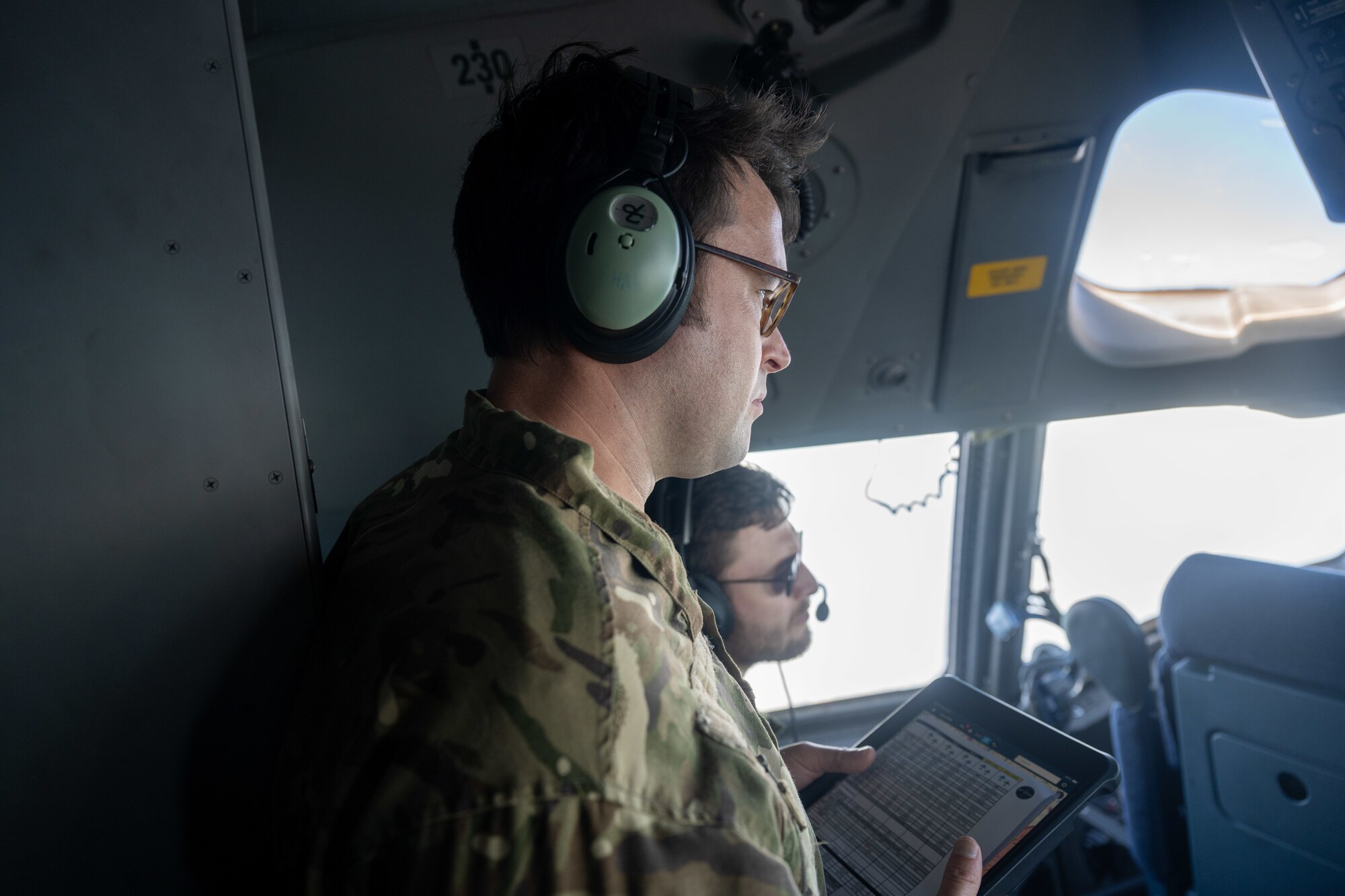 Royal Air Force aircrew observes other C-17 pilots while flying.