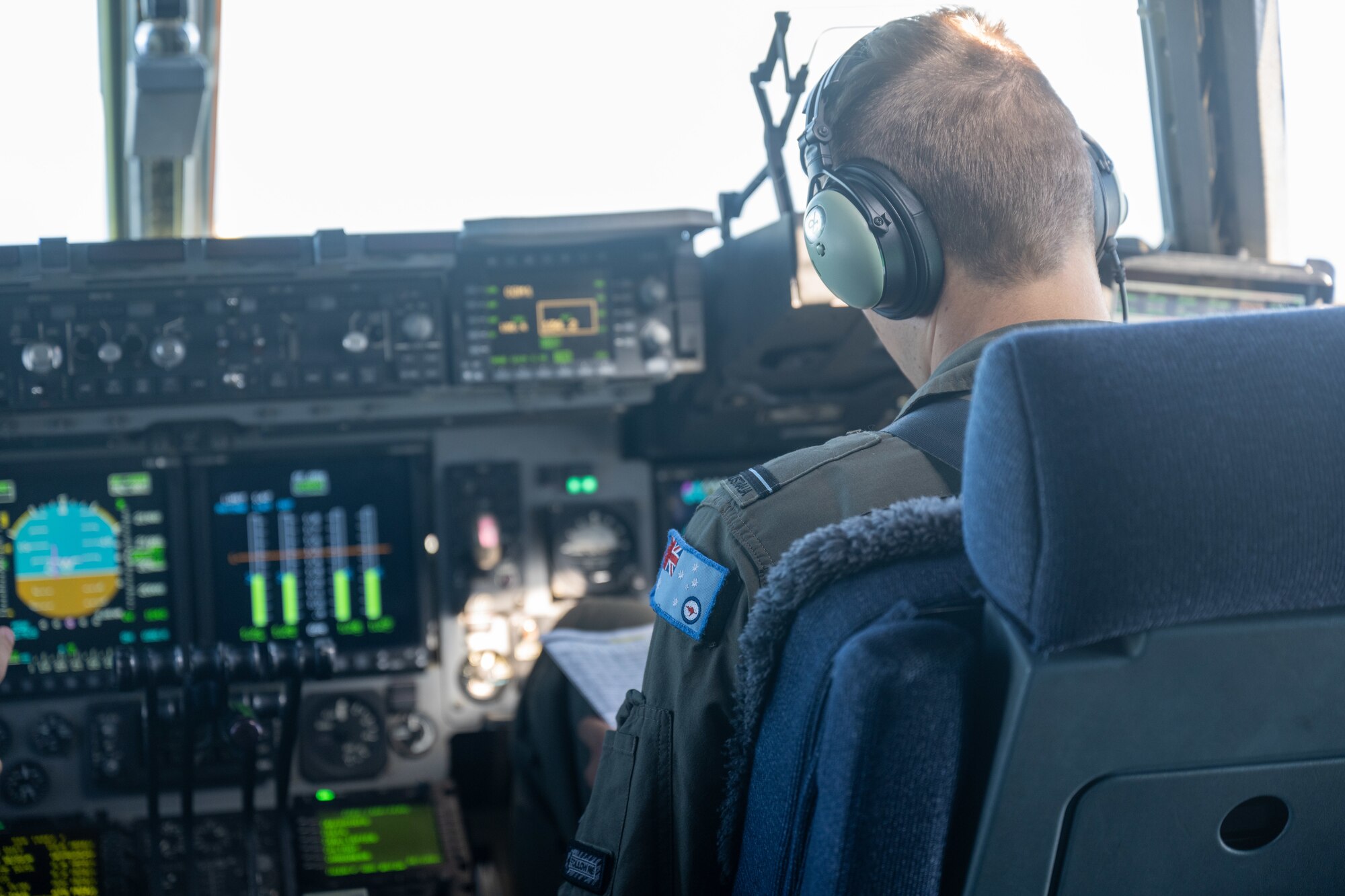 A Royal Australian pilot pilots a C-17 Globemaster III over Australia.