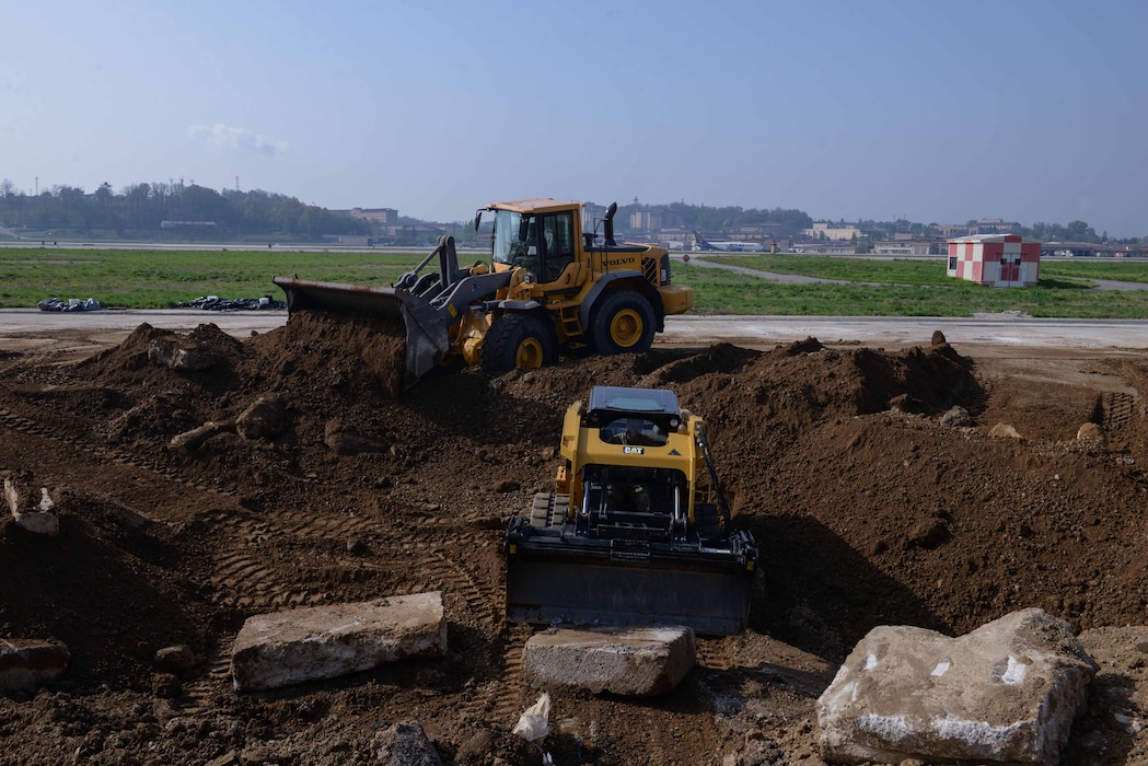 Members of the U.S. Air Force, U.S. Army, Republic of Korea Army and ROK Air Force repair a large crater on the flight line during IRON RADR at Osan Air Base, Republic of Korea, April 24, 2025. IRON RADR is the first complex, joint and combined exercise on Osan AB that tests, evaluates and prepares civil engineers to safely conduct rapid airfield damage repair operations in a simulated contingency environment. (U.S. Air Force photo by Staff Sgt. Kahdija Slaughter)