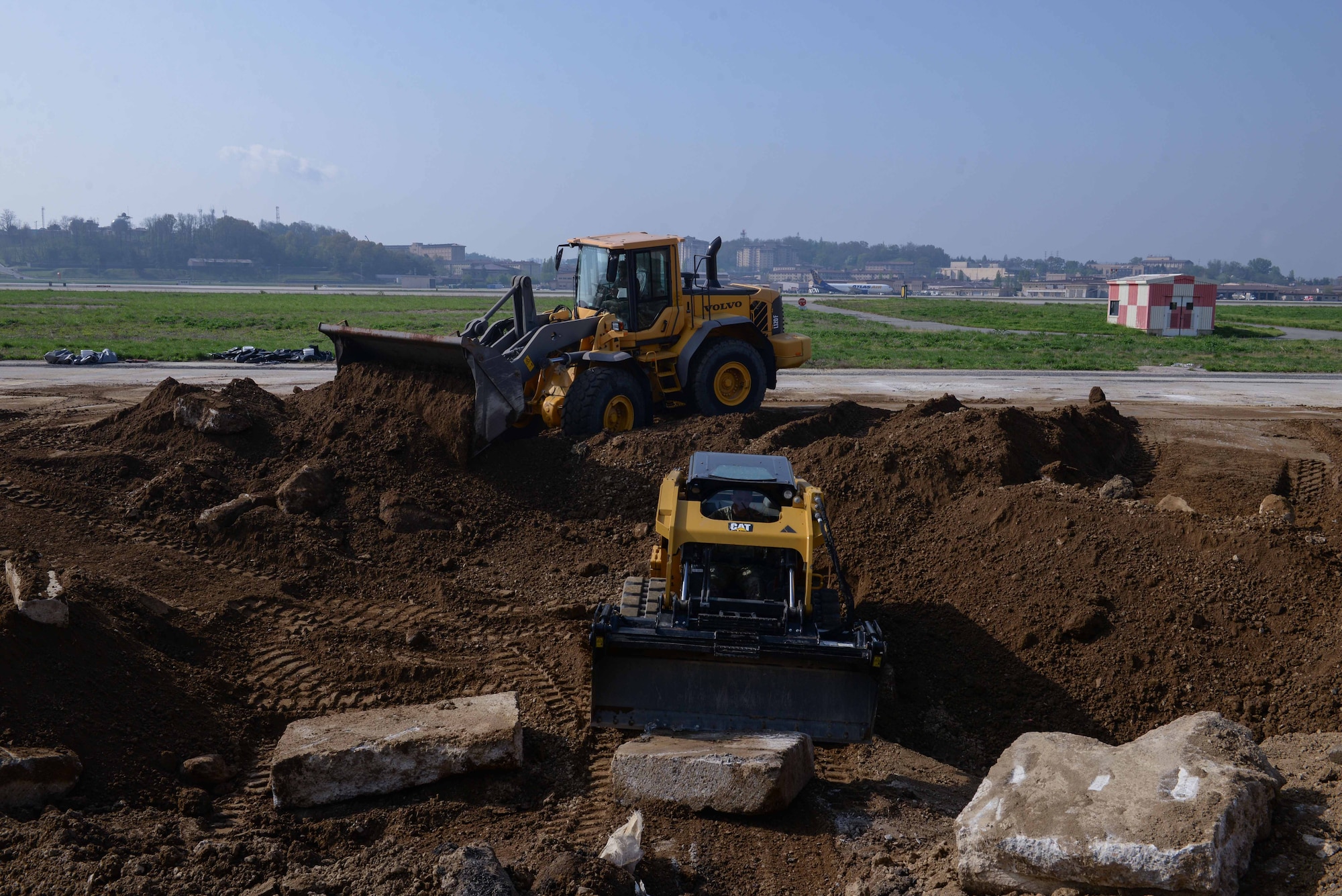 Members of the U.S. Air Force, U.S. Army, Republic of Korea Army and ROK Air Force repair a large crater on the flight line during IRON RADR at Osan Air Base, Republic of Korea, April 24, 2025. IRON RADR is the first complex, joint and combined exercise on Osan AB that tests, evaluates and prepares civil engineers to safely conduct rapid airfield damage repair operations in a simulated contingency environment. (U.S. Air Force photo by Staff Sgt. Kahdija Slaughter)