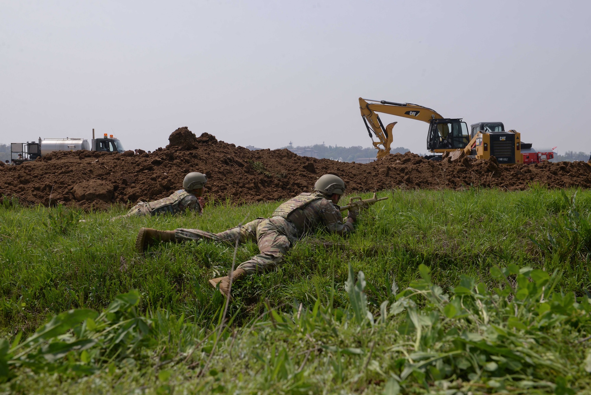 U.S. Air Force Airmen assigned to the 51st Security Forces Squadron respond to a simulated ambush with ground protection maneuvers during IRON RADR at Osan Air Base, Republic of Korea, April 24, 2025. IRON RADR is the 51st Civil Engineer Squadron’s first complex, joint and combined exercise that tested, evaluated and prepared engineers to safely conduct rapid airfield damage repair operations in a simulated contingency environment. (U.S. Air Force photo by Staff Sgt. Kahdija Slaughter)
