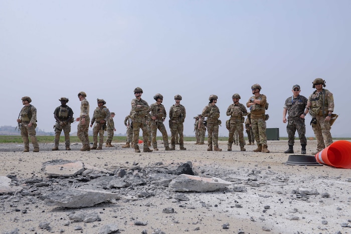 Members of the U.S. Air Force, U.S. Army, U.S. Marine Corps, and Republic of Korea Air Force examine small craters and foreign object debris created by the 51st Civil Engineer Squadron explosive ordnance disposal flight during a joint and combined EOD training at Osan Air Base, Republic of Korea, April 18, 2025. The training created an instructional and hands-on environment to learn and execute tactics, techniques, and procedures when creating explosive ordnances. The detonations prepared during the training laid the realistic foundation needed for a complex rapid airfield damage repair exercise called IRON RADR. (U.S. Air Force photo by Staff Sgt. Kahdija Slaughter)