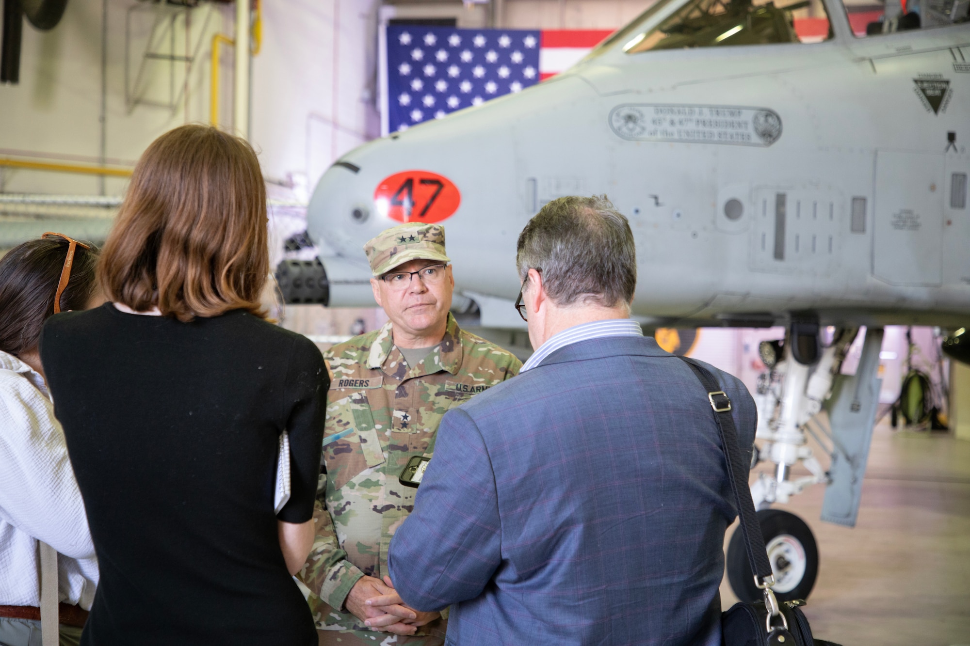 Uniformed military member speaking with civilian media