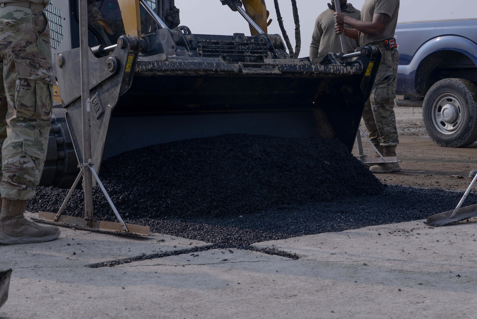 Members of the U.S. Air Force and U.S. Army pour and level asphalt into a small crater during a rapid airfield damage repair training at Osan Air Base, Republic of Korea, April 3, 2025. The RADR mission encompasses advanced pavement repair techniques and strategies that support airfield operations in degraded and contingency conditions, allowing swift restoration of combat airpower generation capabilities no matter the warfighting landscape. This training was hosted prior to IRON RADR, the first complex, joint and combined exercise to test, evaluate and prepare civil engineers to safely conduct RADR operations in a simulated contingency environment. (U.S. Air Force photo by Staff Sgt. Kahdija Slaughter)
