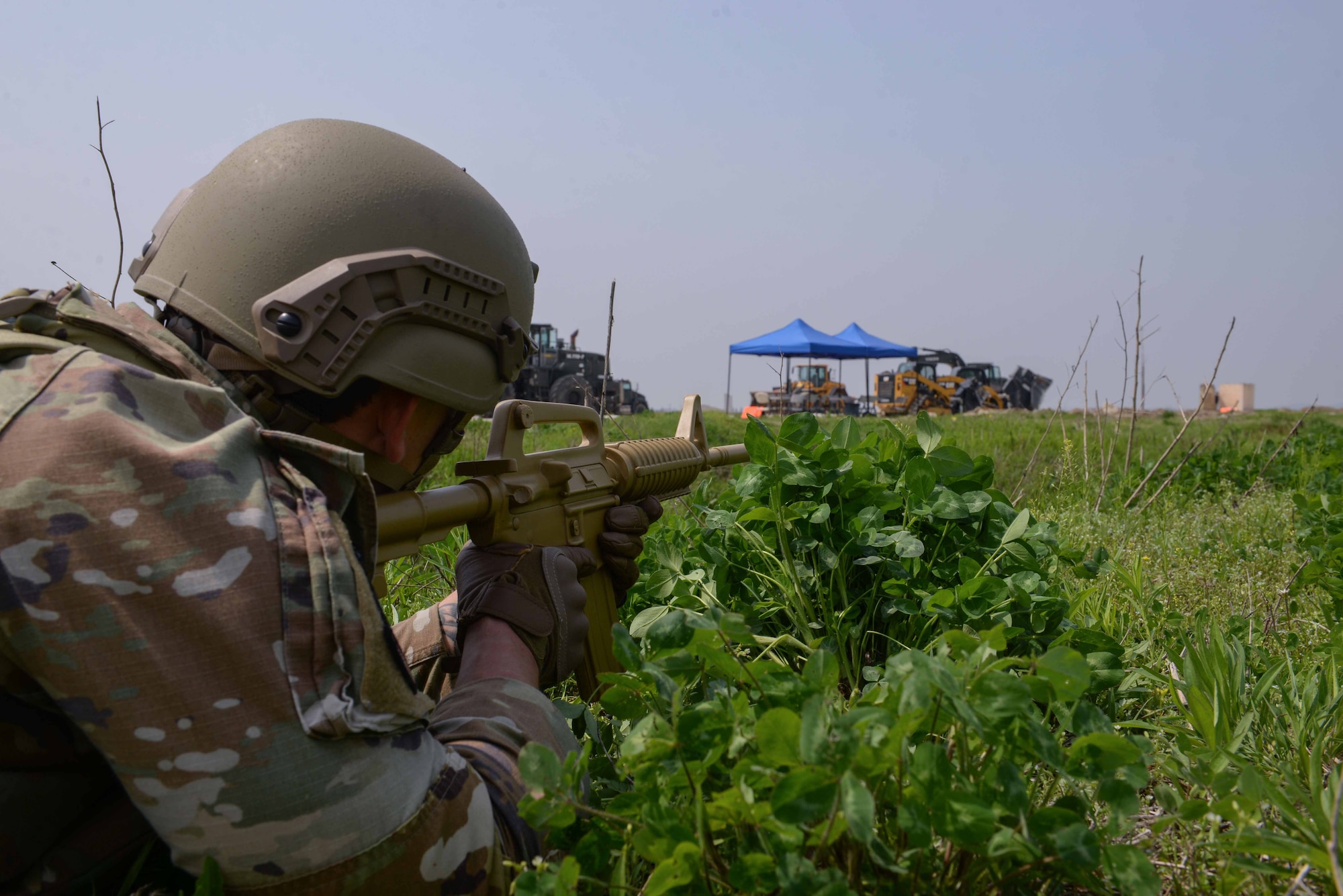 A U.S. Air Force Airman assigned to the 51st Security Forces Squadron aims at simulated enemies ambushing the airfield during IRON RADR at Osan Air Base, Republic of Korea, April 24, 2025. During the exercise, security forces Airmen coordinated simulated air to ground attacks using small unmanned aerial systems, provided perimeter security for rapid airfield damage repair teams, and engaged in simulated ground attacks. The goal of IRON RADR was to test, evaluate, and prepare joint and allied engineers to protect themselves from simulated threats during repair operations; increasing survivability of RADR teams and allowing timely completion of airfield restorations. (U.S. Air Force photo by Staff Sgt. Kahdija Slaughter)