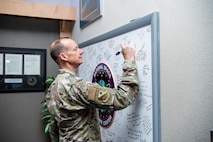 Man in uniform signs board