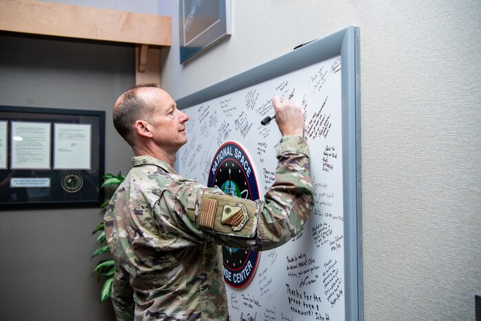 Man in uniform signs board