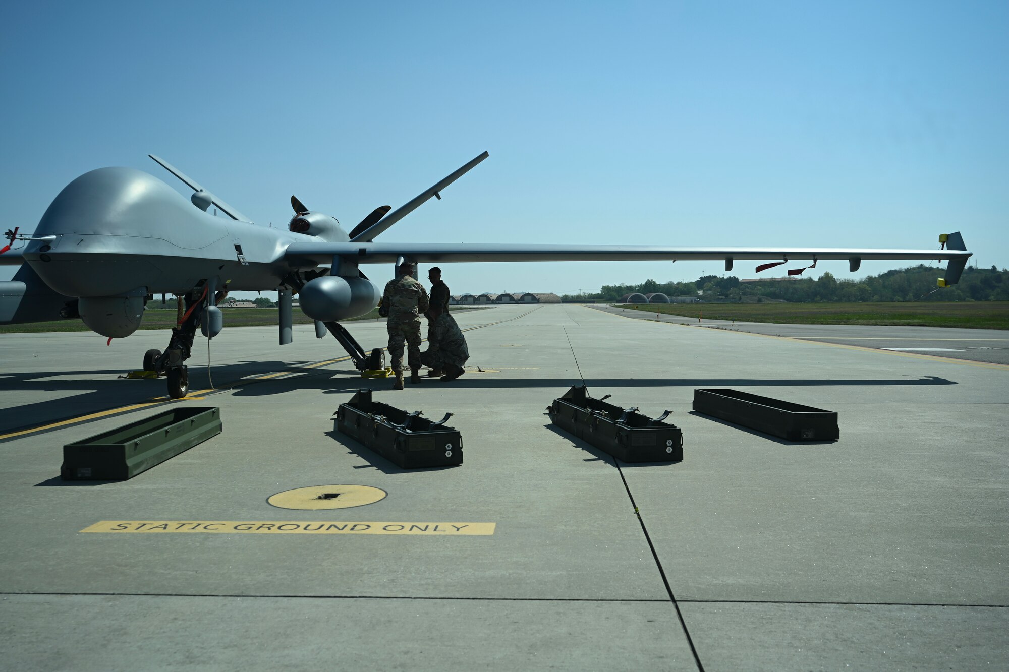 Senior Airman Eduardo Ledezma, Tech. Sgt. Kristopher Speir, and Tech Sgt. Aldrich Aldana, 163d Attack Wing MQ-9 Reaper armament systems specialists, load four AGM-114 Hellfire missiles onto an MQ-9 Reaper at Kunsan Air Base.