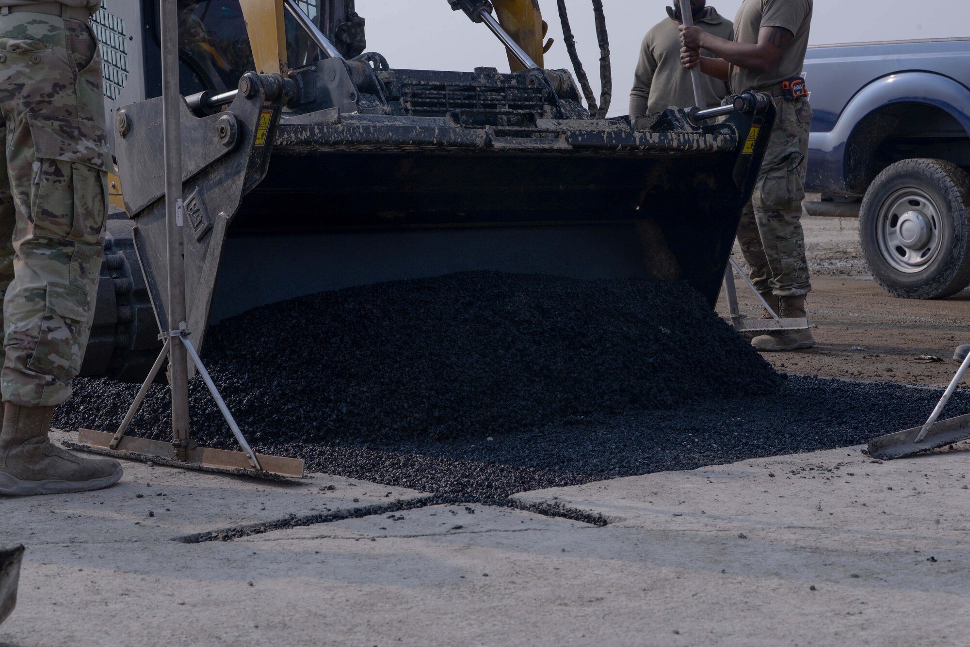 Members of the U.S. Air Force and U.S. Army pour and level asphalt into a small crater during a rapid airfield damage repair training at Osan Air Base, Republic of Korea, April 3, 2025. The RADR mission encompasses advanced pavement repair techniques and strategies that support airfield operations in degraded and contingency conditions, allowing swift restoration of combat airpower generation capabilities no matter the warfighting landscape. This training was hosted prior to IRON RADR, the first complex, joint and combined exercise to test, evaluate and prepare civil engineers to safely conduct RADR operations in a simulated contingency environment. (U.S. Air Force photo by Staff Sgt. Kahdija Slaughter)