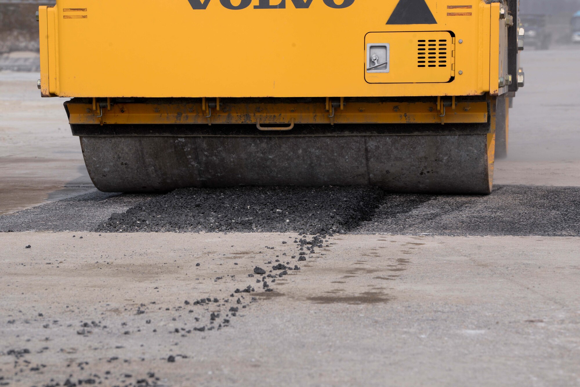 Service members assigned to the 51st Civil Engineer Squadron roll freshly poured asphalt on an airfield pad during a rapid airfield damage repair training at Osan Air Base, Republic of Korea, April 3, 2025. The hands-on training prepared Airmen, Soldiers, and ROK engineers stationed at contingency operating bases across the Korean peninsula to conduct RADR operations during IRON RADR. IRON RADR is the first complex, joint and combined exercise on Osan AB that tests, evaluates and prepares civil engineers to safely conduct RADR operations in a simulated contingency environment. (U.S. Air Force photo by Staff Sgt. Kahdija Slaughter)