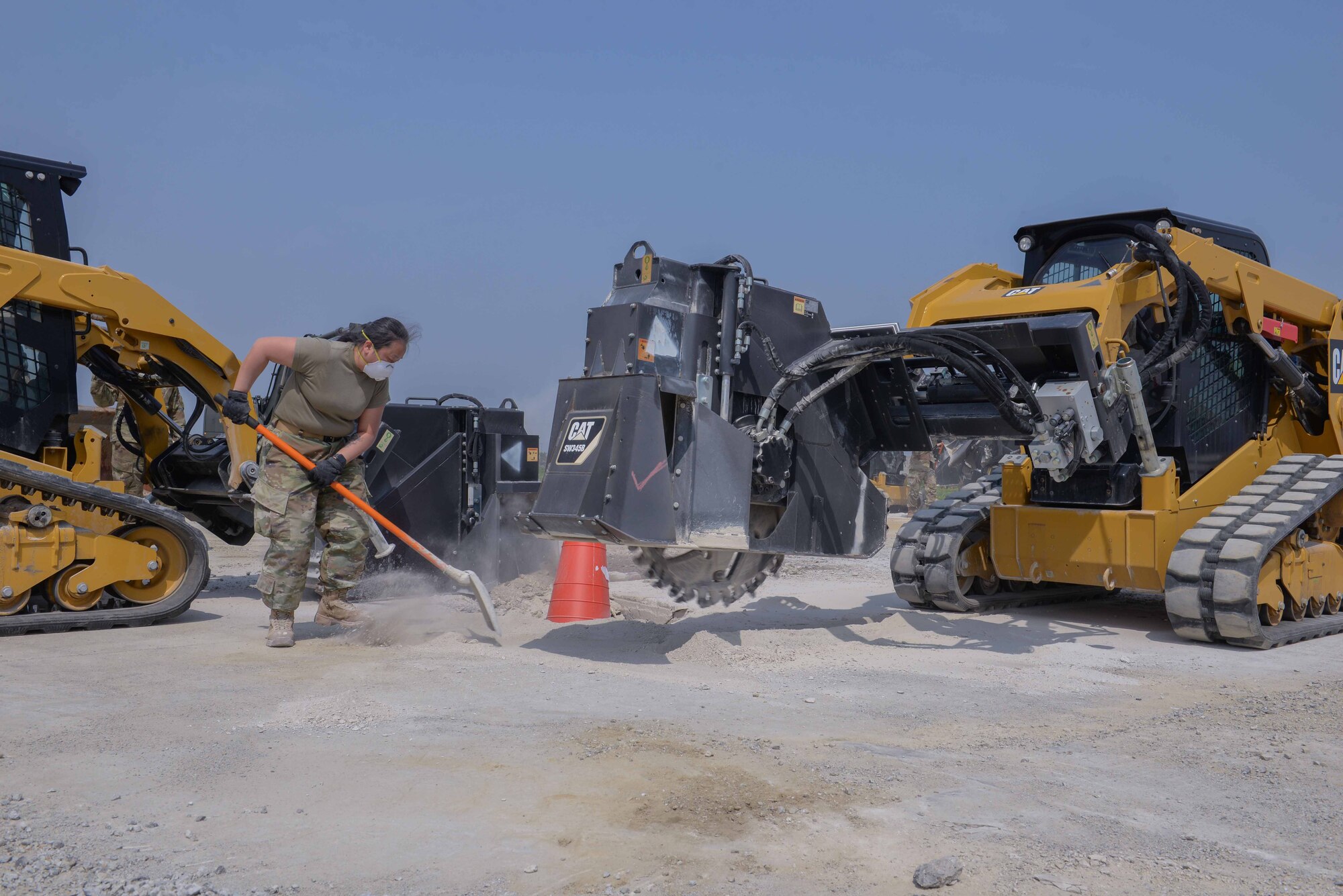 Members of the U.S. Air Force, U.S. Army, U.S. Marine Corps, and Republic of Korea Air Force score and cut around the ground upheaval of a small crater in a concrete airfield pad during IRON RADR at Osan Air Base, Republic of Korea, April 24, 2025. Phases in the rapid airfield damage repair process include debris removal, upheaval marking, pavement cutting, excavating, flowable fill, rapid setting, and curing time. The goal of the IRON RADR exercise was to test, evaluate, and prepare civil engineers to safely conduct RADR operations in a simulated contingency environment. (U.S. Air Force photo by Staff Sgt. Kahdija Slaughter)