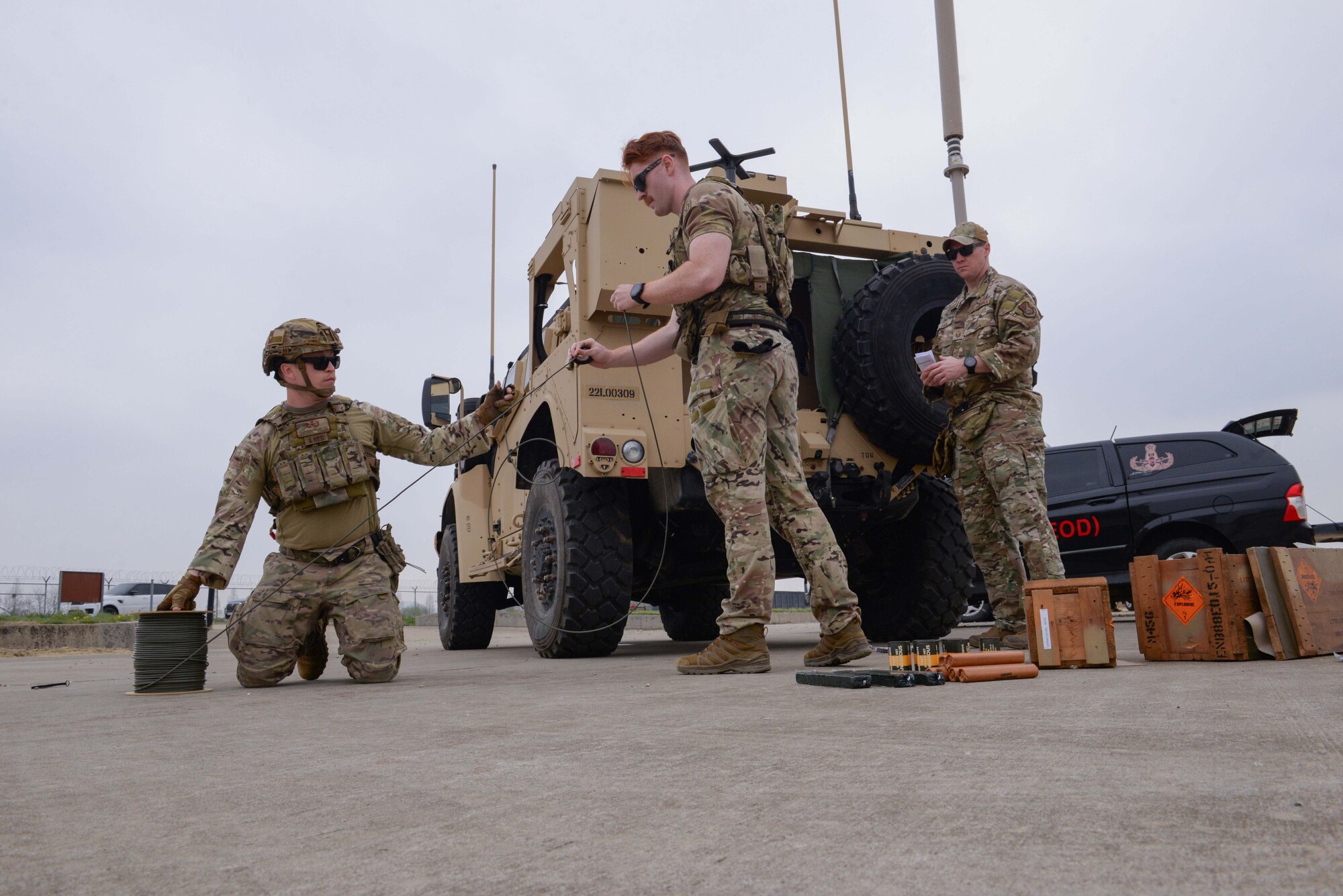 U.S. Airmen assigned to the 51st Civil Engineer Squadron explosive ordnance disposal flight, cut demolition wire for dynamite, TNT and C4 explosives at Osan Air Base, Republic of Korea, April 18, 2025. The EOD Airmen safely rigged explosives to create multiple craters ahead of the first complex, joint and combined IRON RADR exercise at Osan AB. Rapid airfield damage repair is a process for repairing structural damage on airfields to restore combat airpower generation. (U.S. Air Force photo by Staff Sgt. Kahdija Slaughter)