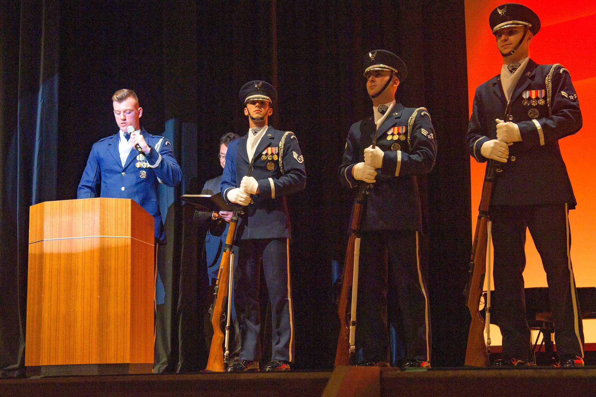 A man speaks to the audience.