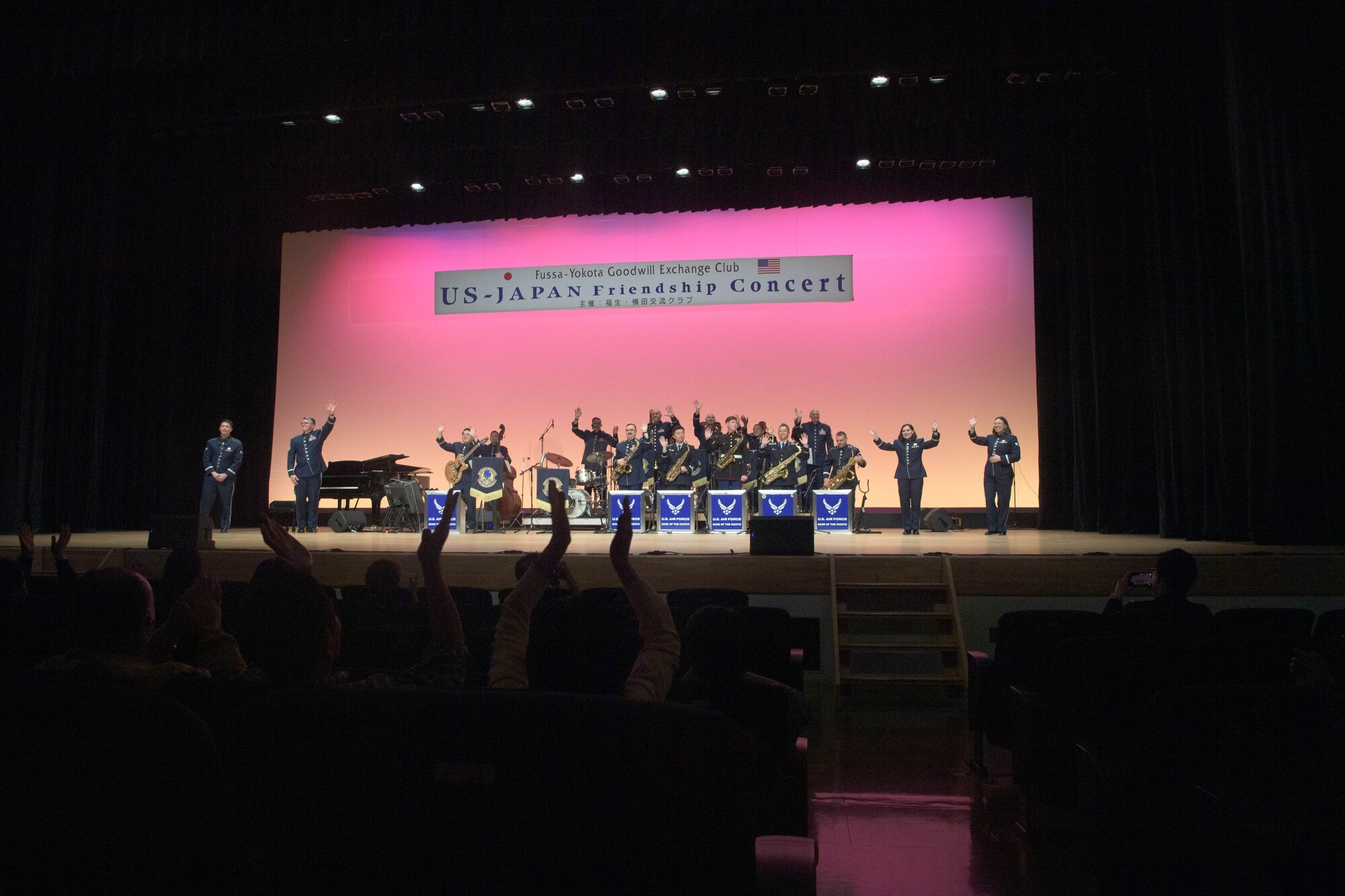 A band waves goodbye.
