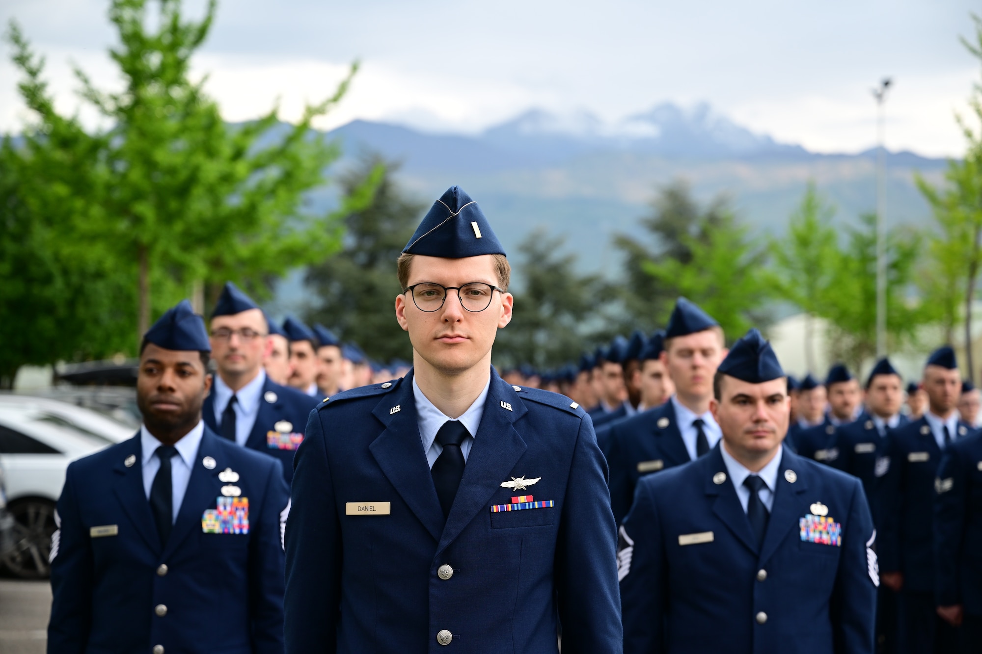 U.S Air Force officer stand with his squadron at attention.