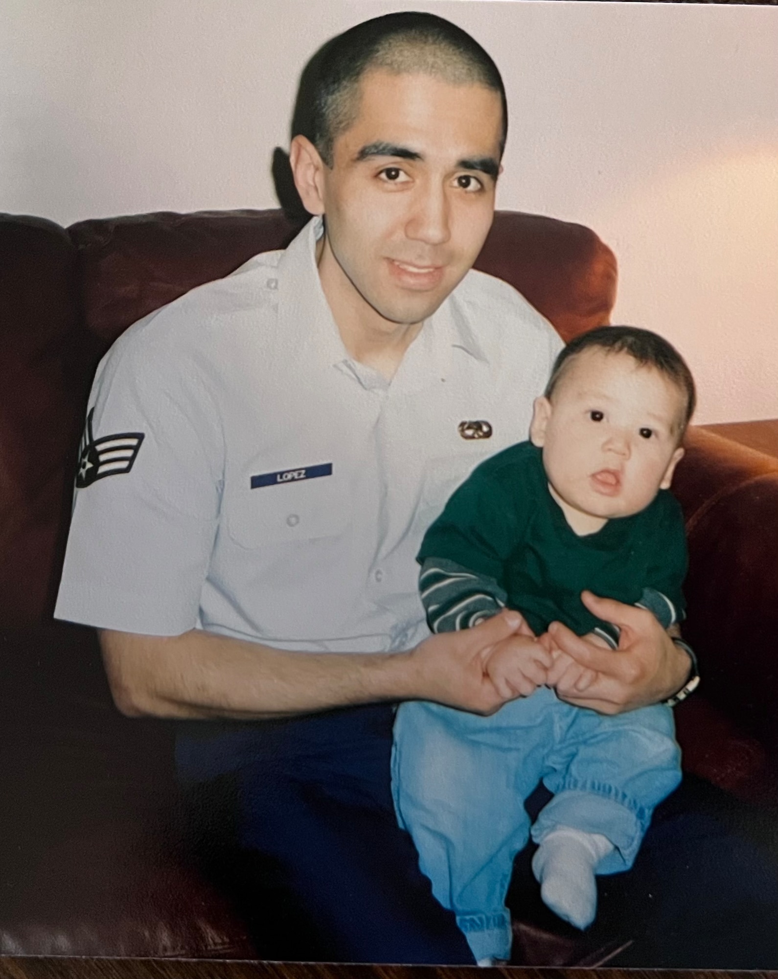 Young Daniel Lopez holds his son Ramon.
