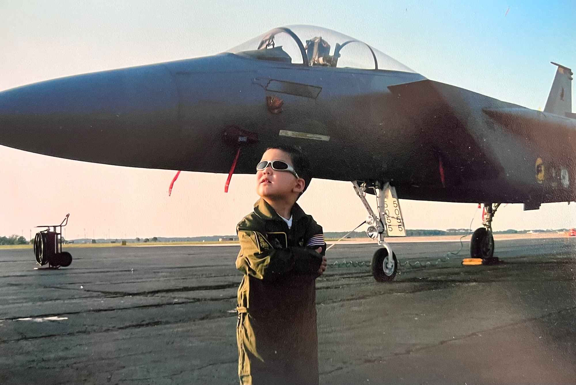 Young Ramon poses for a photo in front of an aircraft.