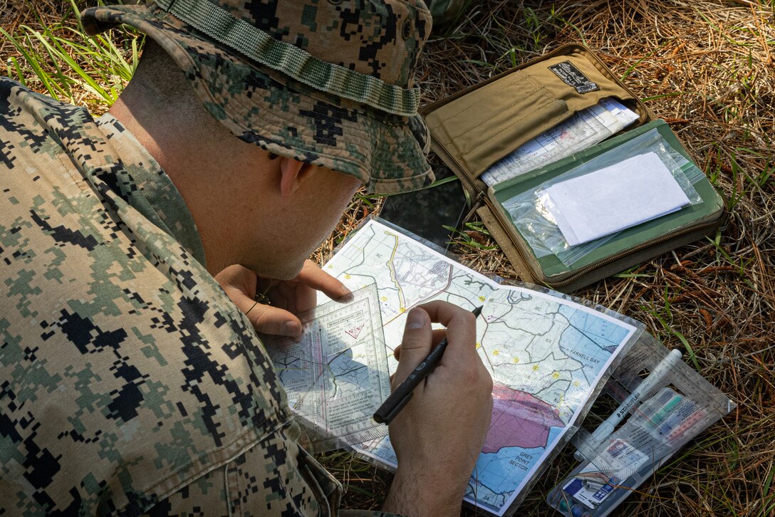 U.S. Marine Corps Sgt. Lewis Lheureux, an infantry rifleman with 2d Battalion, 6th Marine Regiment, 2d Marine Division, identifies landmarks on a map during a Tactical Small Unit Leadership Course on Marine Corps Base Camp Lejeune, North Carolina, April 28, 2025. The TSULC provided small unit leaders with the knowledge, confidence and proficiency to lead Marines in combat scenarios, thereby enhancing team leader abilities for combat-ready forces. (U.S. Marine Corps photo by Lance Cpl. Judith Ann Lazaro)