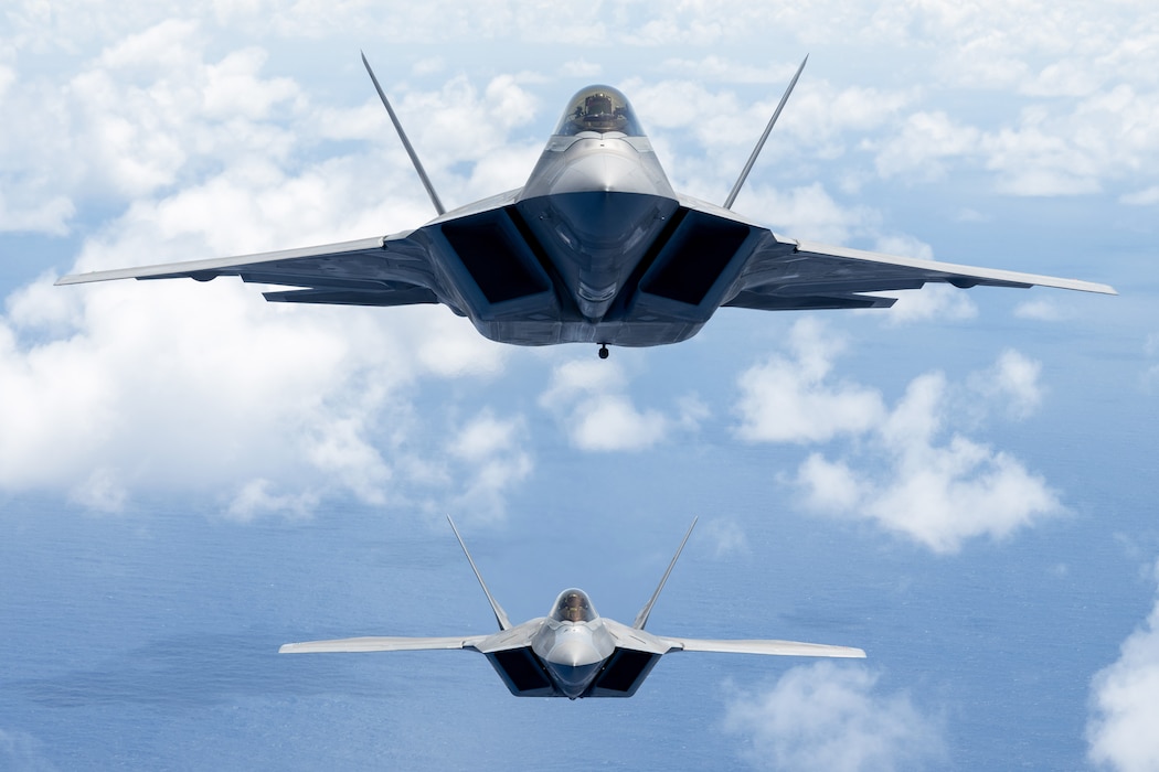 F-22s flying over ocean