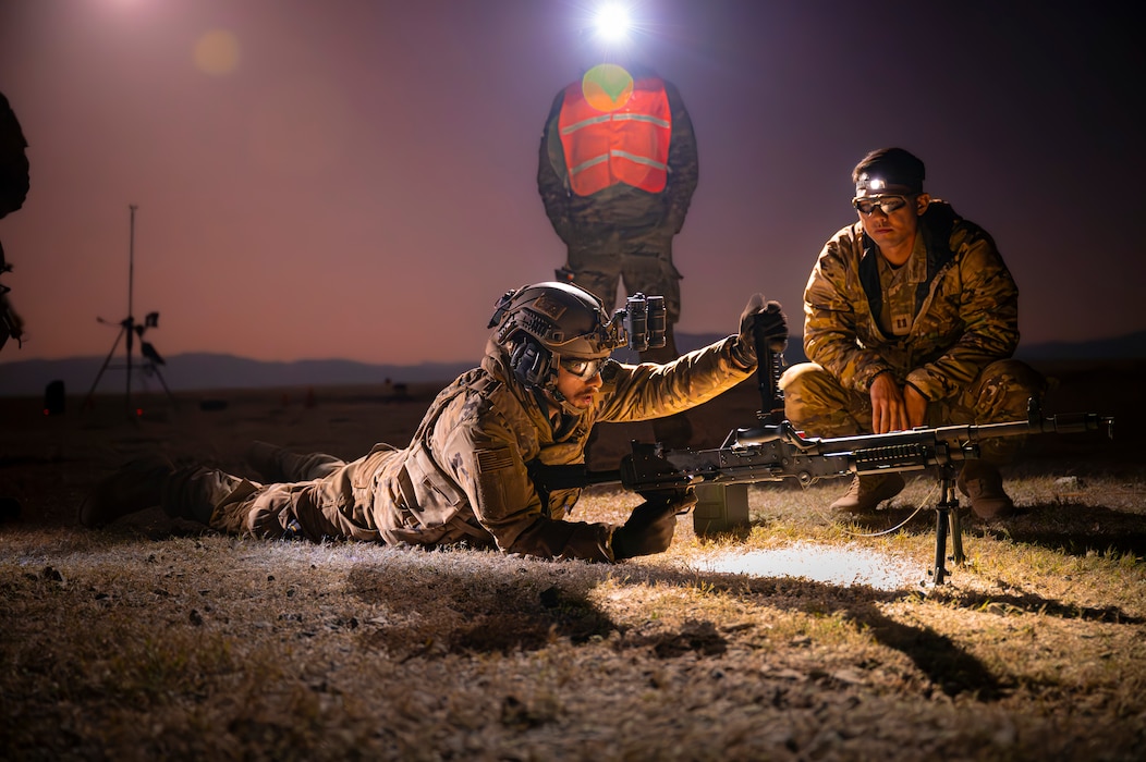 Airman lying on ground with a machine gun