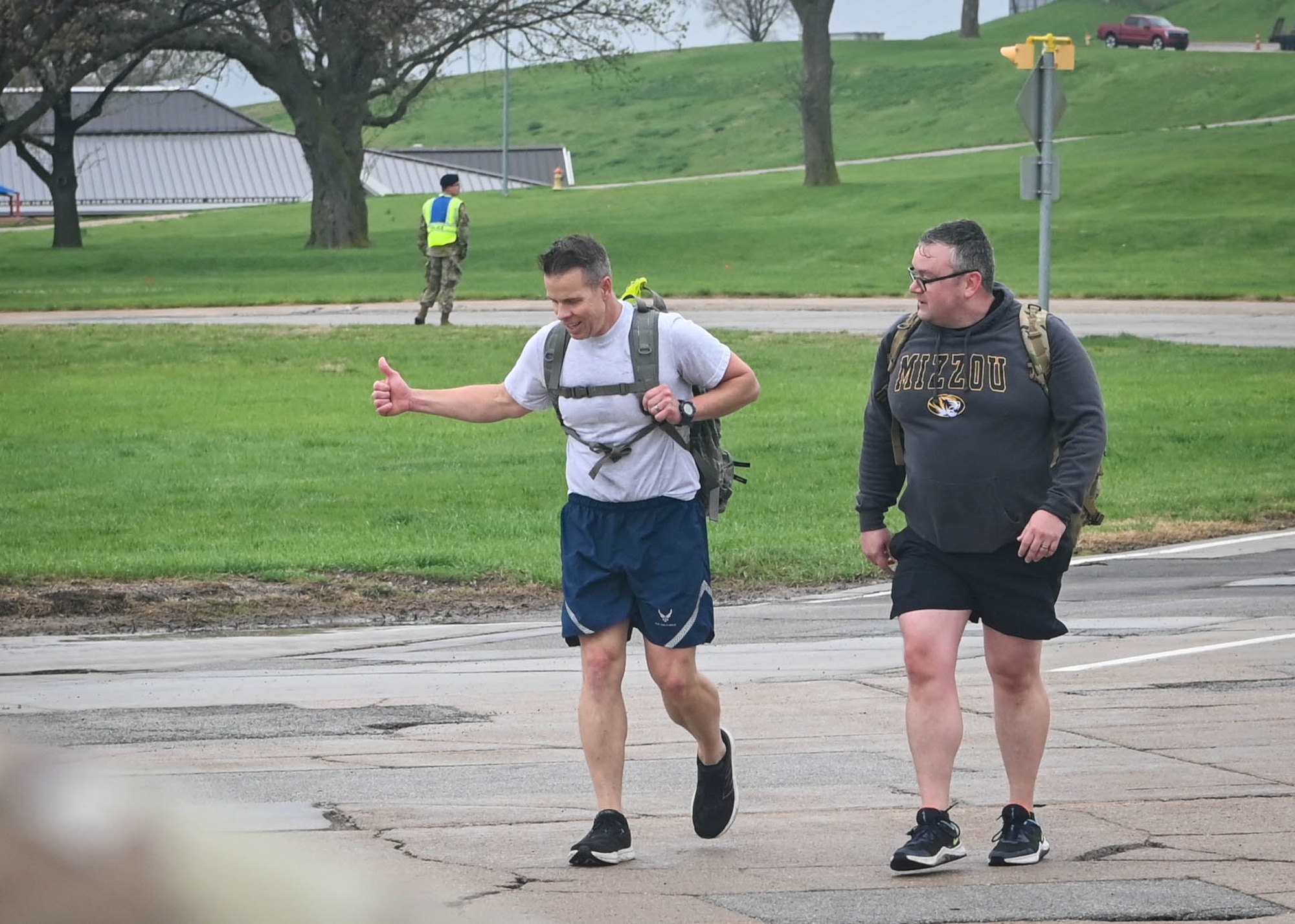 Col. Hank Chilcoat, 1st Weather Group commander, and Senior Master Sgt. Matthew Renkosiak, 1st WXG operations superintendent, complete the Capt. Nathan Nylander Memorial ruck march at the 557 the Weather Wing, April 25, 2025. Nylander, a weather officer who was assigned to the 25th Operational Weather Squadron at Davis-Monthan Air Force Base, Arizona, was killed along with eight others during a shooting at Kabul International Airport on April 27, 2011. (U.S. Air Force photo by Daniel Martinez)