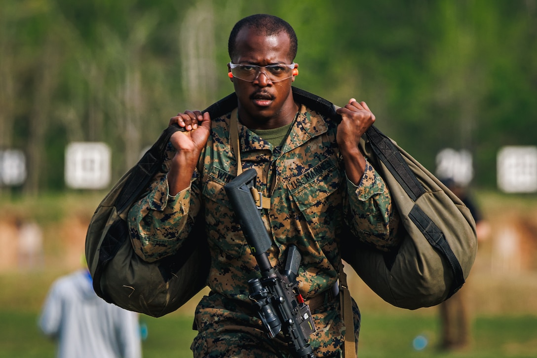 U.S Marine Corps Staff Sgt. Tyree Whitfield, a force fitness instructor trainer with the Martial Arts and Fitness Center of Excellence, carries a sandbag while conducting the “Locate & Close With” event during the Fittest Instructor Competition at Weapons Training Battalion on Marine Corps Base Quantico, Virginia, April 25, 2025. The Fittest Instructor Competition brought together instructors from across the Marine Corps to go head-to-head in a series of demanding physical challenges-all to determine who truly earns the title of the fittest instructor. (U.S. Marine Corps photo by Lance Cpl. Braydon Rogers)