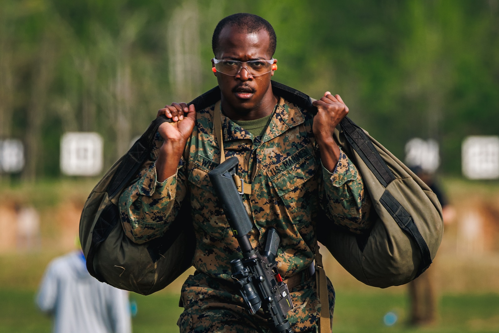 U.S Marine Corps Staff Sgt. Tyree Whitfield, a force fitness instructor trainer with the Martial Arts and Fitness Center of Excellence, carries a sandbag while conducting the “Locate & Close With” event during the Fittest Instructor Competition at Weapons Training Battalion on Marine Corps Base Quantico, Virginia, April 25, 2025. The Fittest Instructor Competition brought together instructors from across the Marine Corps to go head-to-head in a series of demanding physical challenges-all to determine who truly earns the title of the fittest instructor. (U.S. Marine Corps photo by Lance Cpl. Braydon Rogers)