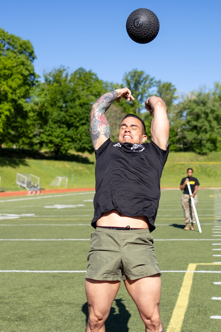 U.S. Marine Corps Staff Sgt. Arian Maceda, an instructor with the Marine Corps School of Artillery, preforms a standing power throw during the Training Command’s Fittest Instructor Competition on Marine Corps Base Quantico, Virginia, April 28, 2025. The Fittest Instructor Competition determines which Marine is the most fit across the major support elements of Training Command while supplementing those competitors with increased education in aerobics, nutrition, and exercise.  (U.S. Marine Corps photo by James Frank)