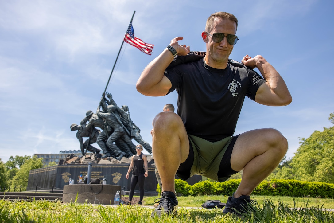 U.S. Marine Corps Maj. Roger Johnson, the executive officer with the Personnel Administration School, performs squats during the event “Manion WOD” at the Iwo Jima Memorial, Arlington, Virginia, April 29, 2025. The Manion Hero WOD (Workout of the Day), dedicated to 1stLt Travis Manion, USMC, brings veterans, families of the fallen, and inspired civilians together each year to honor Manion’s’ life and legacy on and around the anniversary of his sacrifice. The Fittest Instructor Competition brought together instructors from across the Marine Corps to go head-to-head in a series of demanding physical challenges-all to determine who truly earns the title of the fittest instructor. (U.S. Marine Corps photo by Lance Cpl. Federico Marquez)