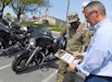 Wally Edwards, right, safety and occupational health manager for U.S. Army Medical Logistics Command, goes over a pre-ride inspection checklist, known as T-CLOCS, for motorcycles with Capt. Paul Abucher at Fort Detrick, Maryland, on April 29. T-CLOCS stands for Tires, Controls, Lights, Oil, Chassis, and Stand. The month of May is Motorcycle Safety Awareness Month, and AMLC leaders urge all riders – as well as motorists – to use caution on the roadways as rider activity increases during the warmer spring and summer months.