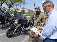 Wally Edwards, right, safety and occupational health manager for U.S. Army Medical Logistics Command, goes over a pre-ride inspection checklist, known as T-CLOCS, for motorcycles with Capt. Paul Abucher at Fort Detrick, Maryland, on April 29. T-CLOCS stands for Tires, Controls, Lights, Oil, Chassis, and Stand. The month of May is Motorcycle Safety Awareness Month, and AMLC leaders urge all riders – as well as motorists – to use caution on the roadways as rider activity increases during the warmer spring and summer months.