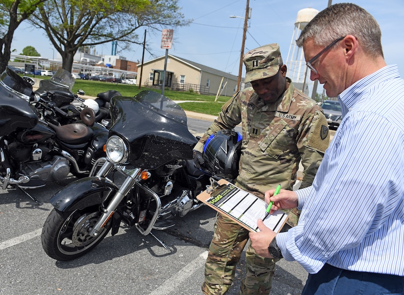Wally Edwards, right, safety and occupational health manager for U.S. Army Medical Logistics Command, goes over a pre-ride inspection checklist, known as T-CLOCS, for motorcycles with Capt. Paul Abucher at Fort Detrick, Maryland, on April 29. T-CLOCS stands for Tires, Controls, Lights, Oil, Chassis, and Stand. The month of May is Motorcycle Safety Awareness Month, and AMLC leaders urge all riders – as well as motorists – to use caution on the roadways as rider activity increases during the warmer spring and summer months.