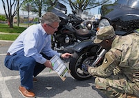 Wally Edwards, left, safety and occupational health manager for U.S. Army Medical Logistics Command, goes over a pre-ride inspection checklist, known as T-CLOCS, for motorcycles with Capt. Paul Abucher at Fort Detrick, Maryland, on April 29. T-CLOCS stands for Tires, Controls, Lights, Oil, Chassis, and Stand. The month of May is Motorcycle Safety Awareness Month, and AMLC leaders urge all riders – as well as motorists – to use caution on the roadways as rider activity increases during the warmer spring and summer months.