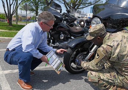 Wally Edwards, left, safety and occupational health manager for U.S. Army Medical Logistics Command, goes over a pre-ride inspection checklist, known as T-CLOCS, for motorcycles with Capt. Paul Abucher at Fort Detrick, Maryland, on April 29. T-CLOCS stands for Tires, Controls, Lights, Oil, Chassis, and Stand. The month of May is Motorcycle Safety Awareness Month, and AMLC leaders urge all riders – as well as motorists – to use caution on the roadways as rider activity increases during the warmer spring and summer months.