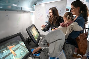 A family interacts with an exhibit during the STEM carnival