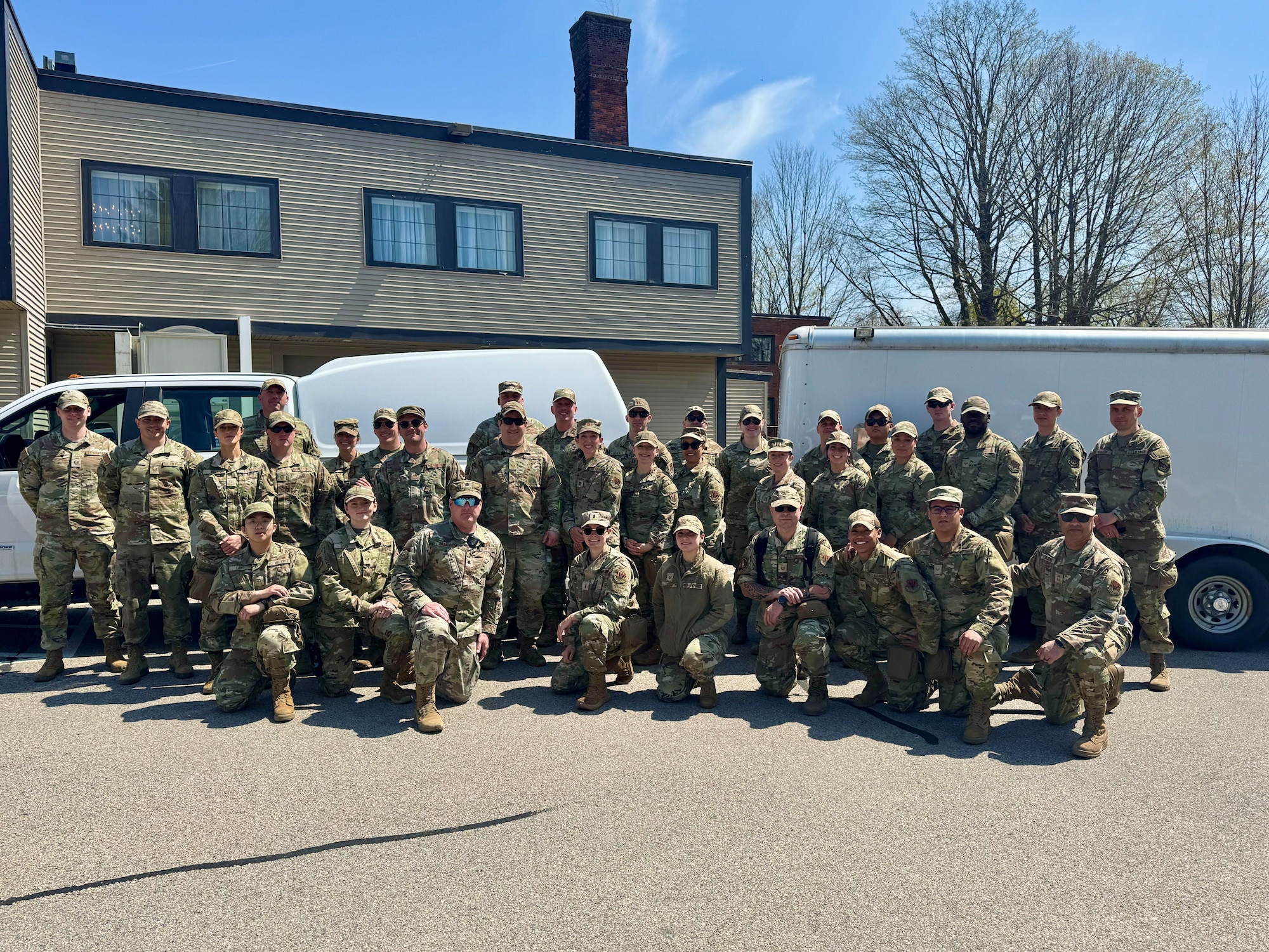 A photo of a large group of military medics standing outdoors in preparation for emergency medial operations.